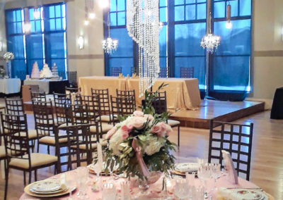 A table set up for an event with chairs and tables.