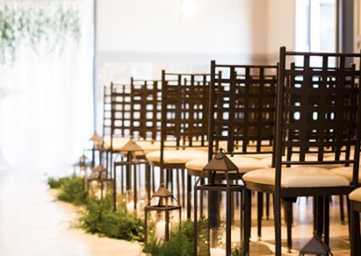 Lanterns and candlelight lining ceremony aisle