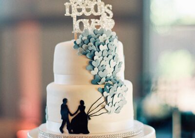 White wedding cake with cascading blue hearts