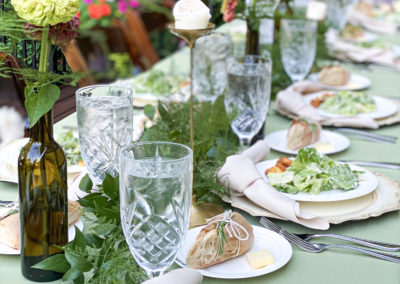 A table set with plates, glasses and silverware.
